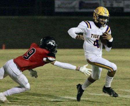 Lemoore's quarterback, Ty Chambers, avoids a tackle for a short game Friday night in the first quarter.